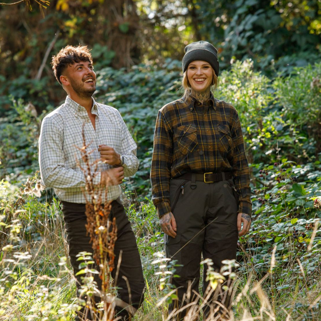 Two people wearing Jack Pyke classic checked Countryman long sleeved shirts outdoors