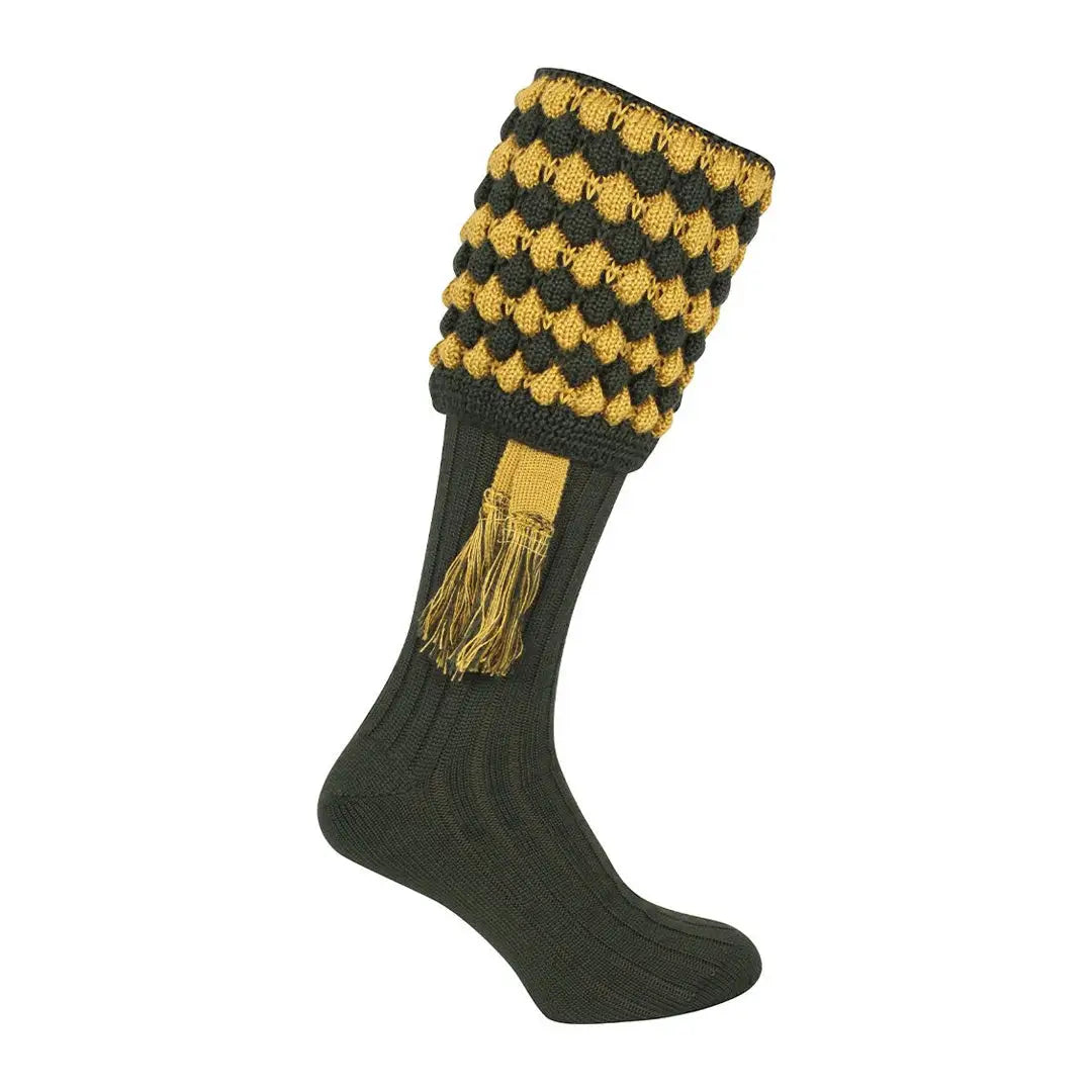 Knee-high Jack Pyke Pebble Shooting Socks with black and yellow pattern and tassels