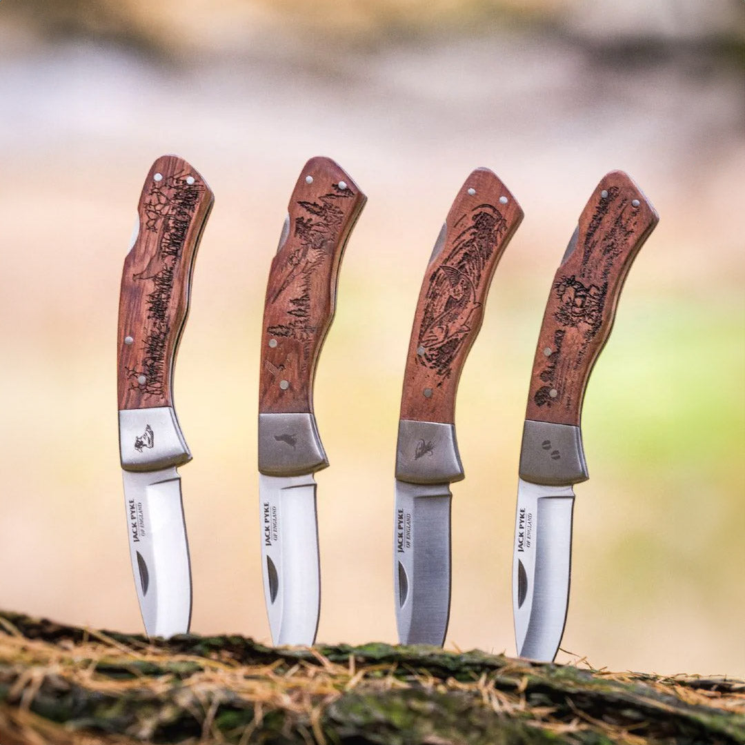 Four Jack Pyke Shires folding knives with stylish wooden handles displayed together