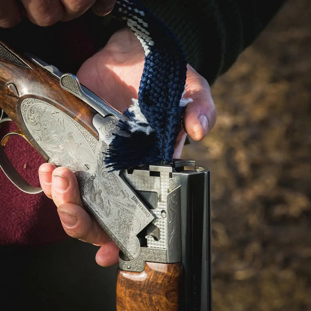 Ornate double-barreled shotgun opened at the breach with Jack Pyke Snaky Shotgun Bore Cleaner