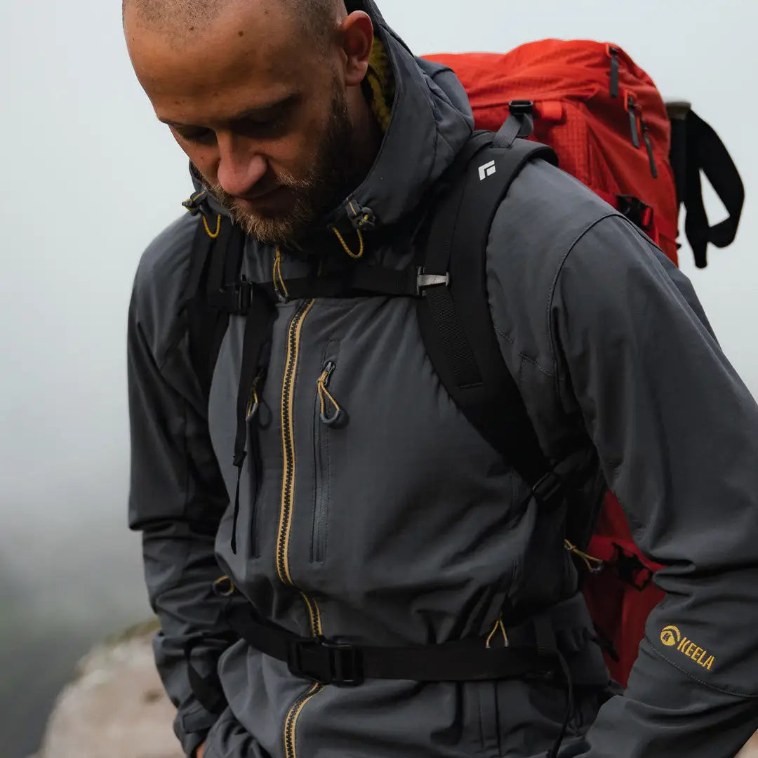 Bearded guy in a gray Keela Hydron Softshell Jacket with a red backpack