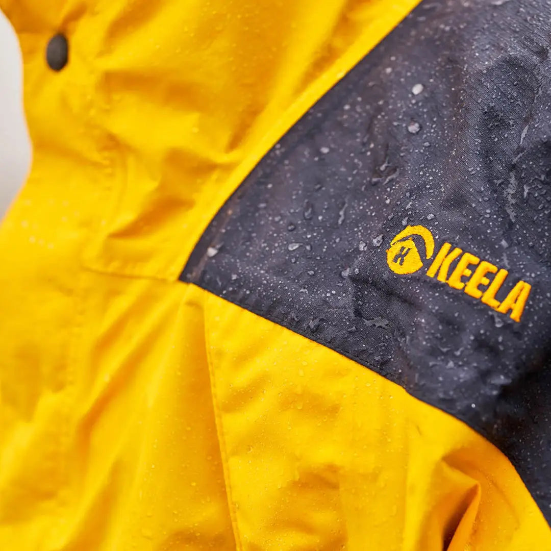 Bright yellow Keela Munro Jacket with black waterproof patch and Neela logo