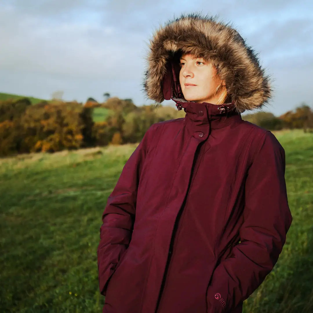 Burgundy winter coat with fur-trimmed hood perfect for country clothing and outdoor adventures