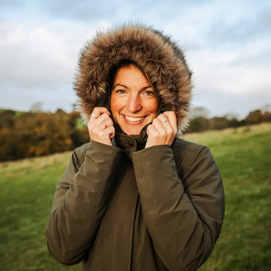 Happy person in a fur-trimmed hooded coat enjoying the outdoors in a Keela Crofter Parka