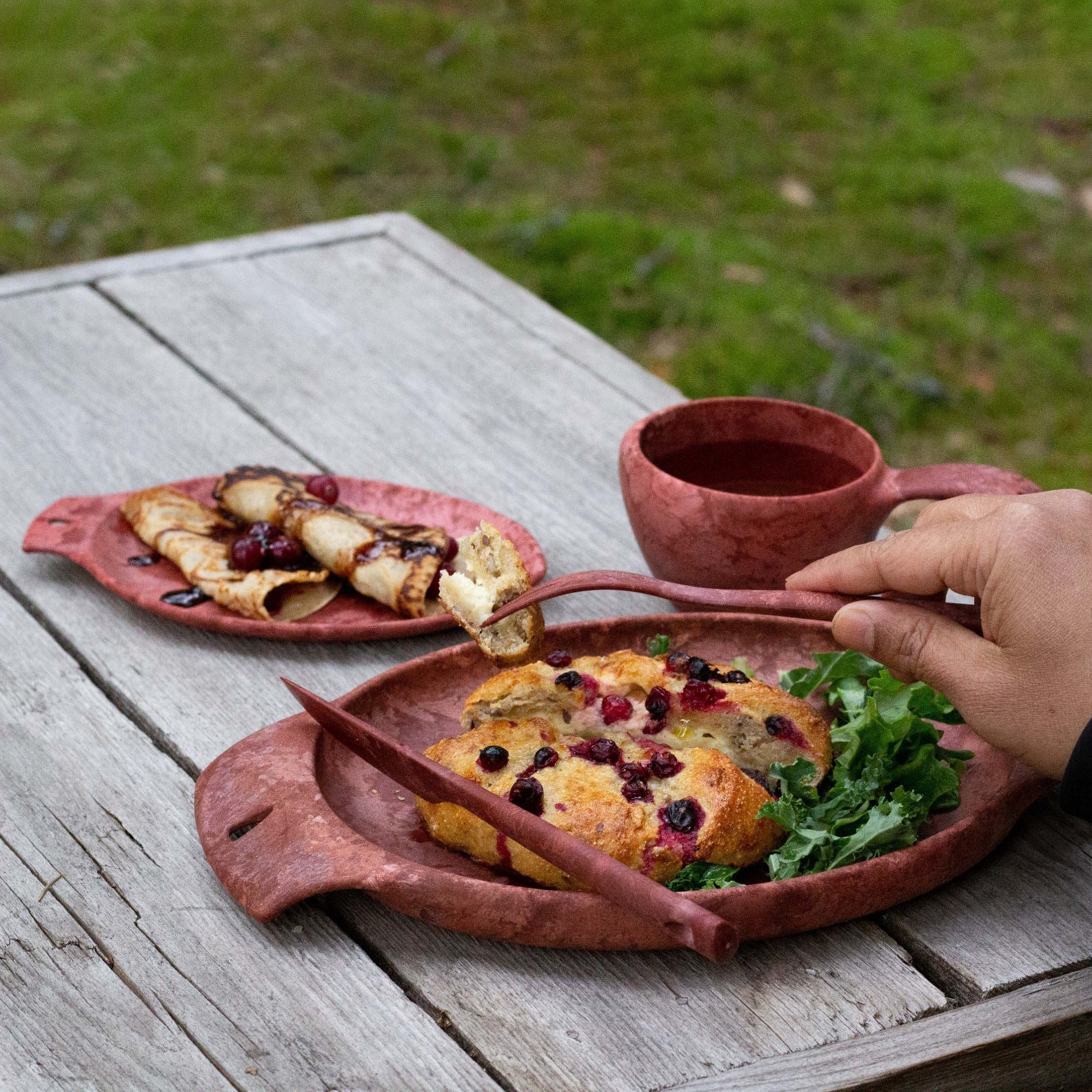 Handcrafted wooden tableware with food from Kupilka Cutlery Set for outdoor dining