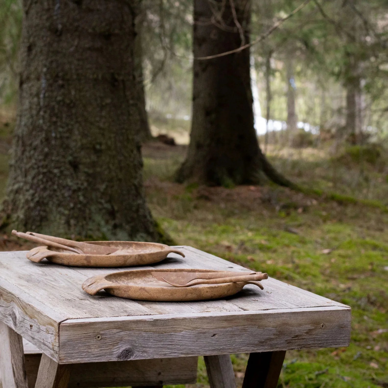 Two wooden serving bowls and utensils from the Kupilka Fill That Belly Gift Set