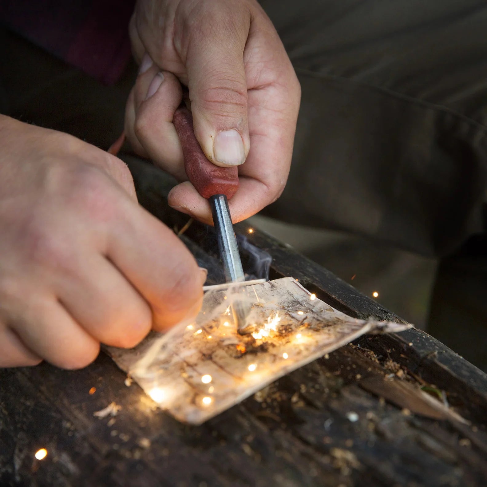 Fire starter in use with Kupilka Firesteel, the ultimate compact striker for country clothing