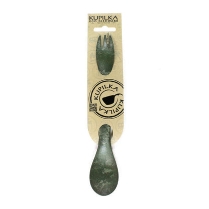 Green spork in packaging, perfect for camping and outdoor adventures with Kupilka