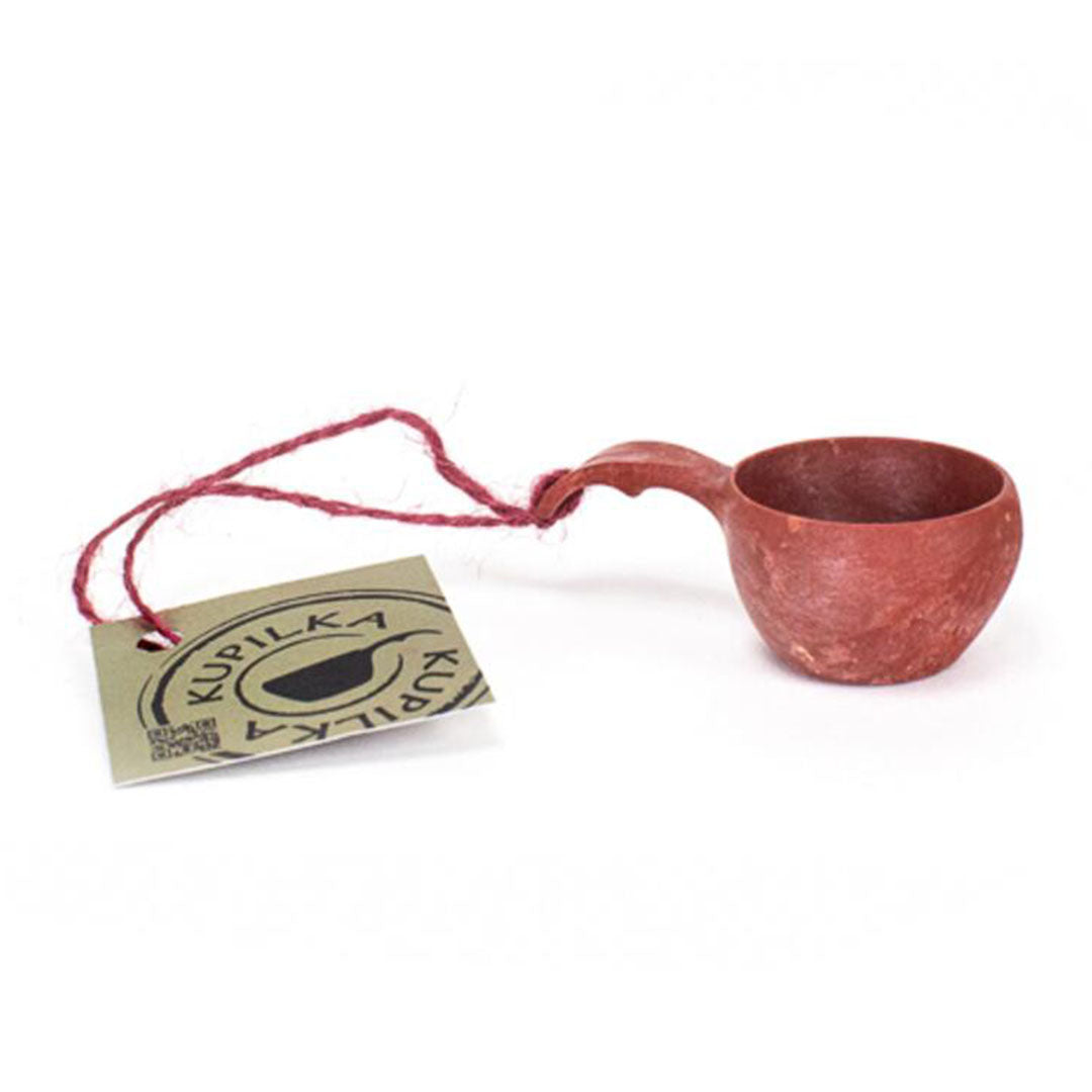 Reddish-brown wooden Kupilka Mini Cup with tag showcasing its unique design and charm