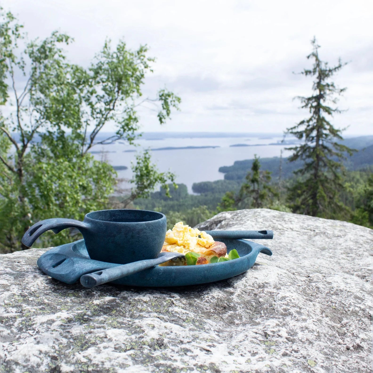 Blue Kupilka Plate with tasty food, perfect for camping and outdoor adventures