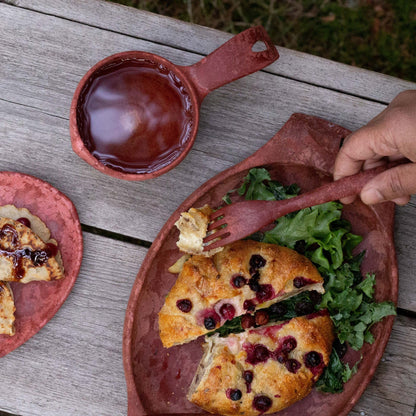 Rustic red-brown tableware with food in Kupilka Premium Gift Set. Perfect for gatherings