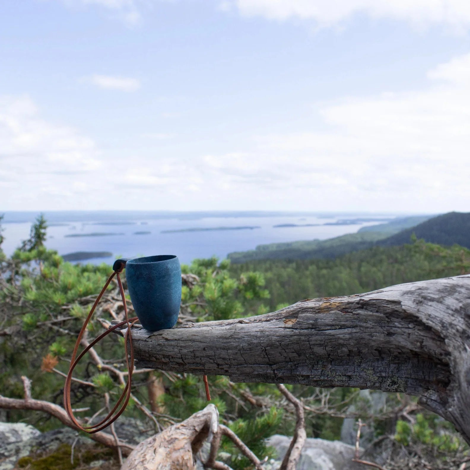 Blue speckled Kupilka Shot Cup with leather cord, perfect for country clothing and hunting