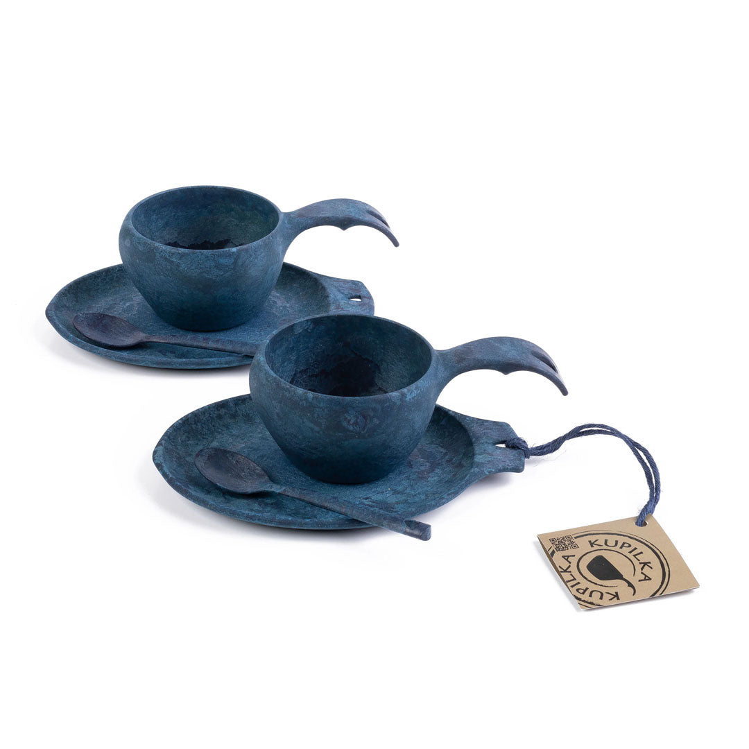 Two blue Kupilka Slow Down Gift Set cups and saucers with spoons and tags