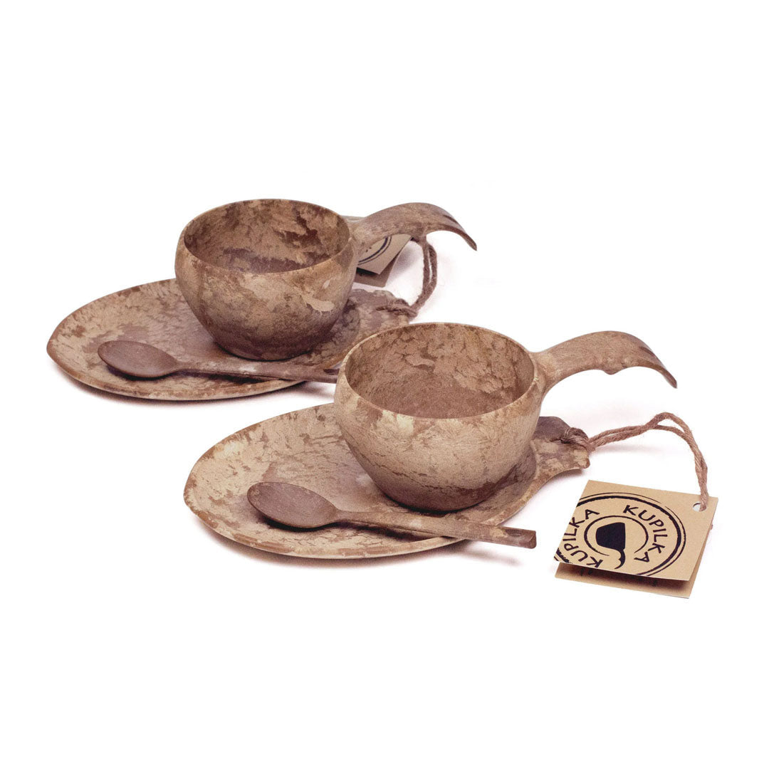 Two brown cup and saucer sets from the Kupilka Slow Down Gift Set, perfect for cozy moments