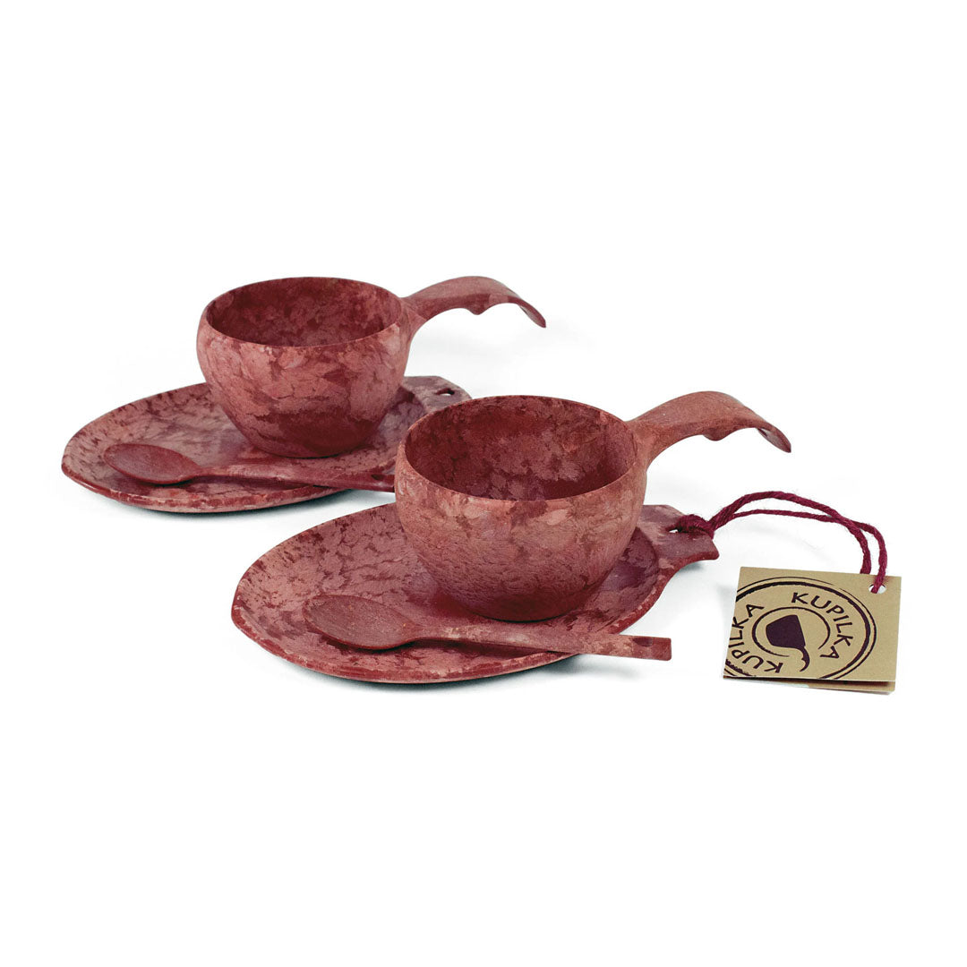 Two reddish-brown Kupilka Slow Down Gift Set cup and saucer sets with spoons