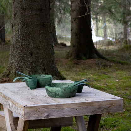 Green speckled bowls and cups from Kupilka Start, perfect for enjoying your favorite liqueur