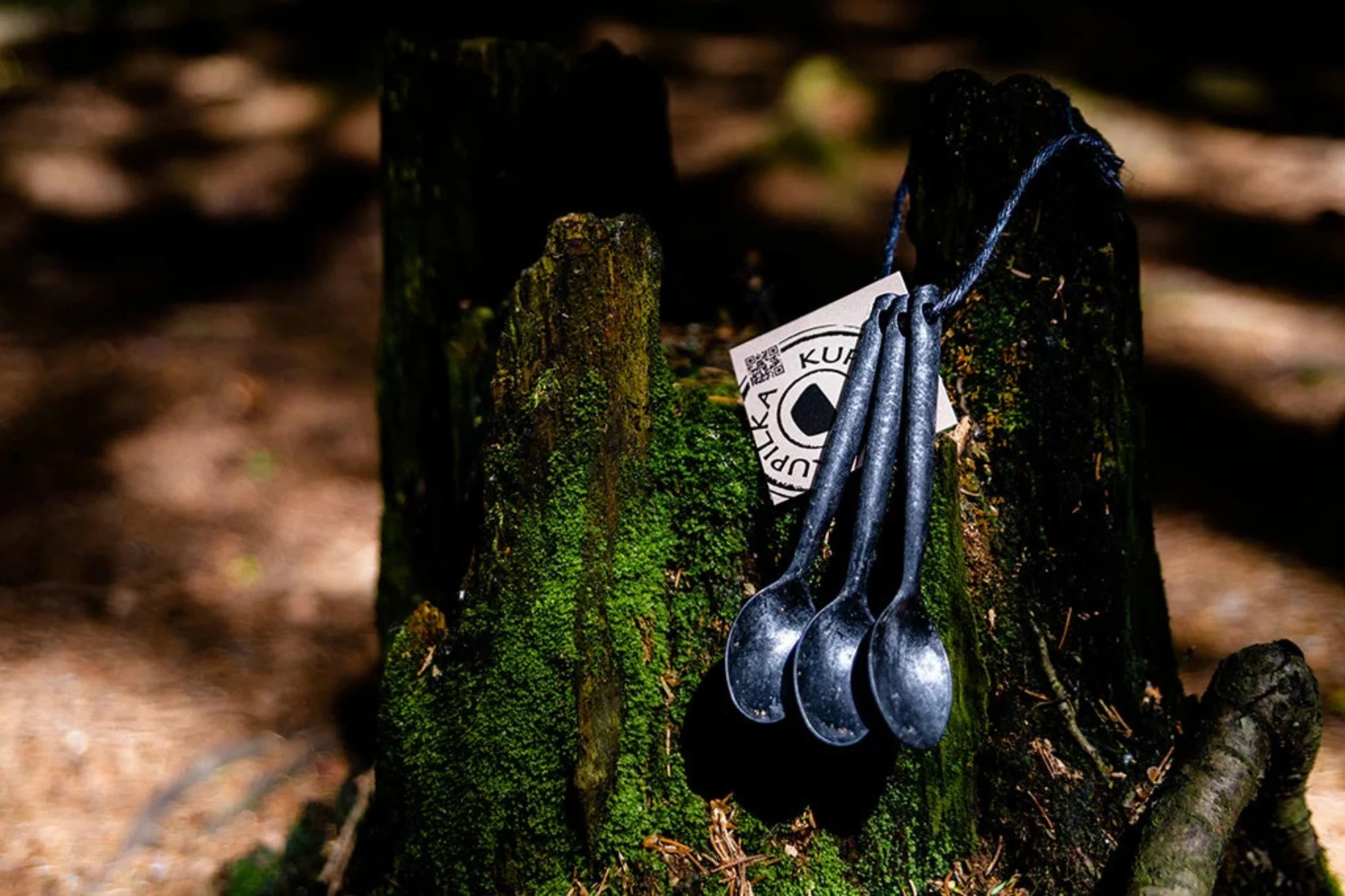 Four dark metal spoons from the Kupilka Teaspoon Set for stylish serving