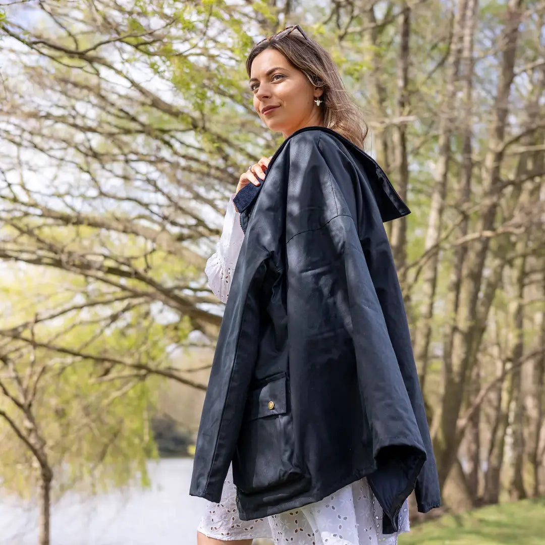 Woman in a navy blue padded wax jacket enjoying the outdoors in nature