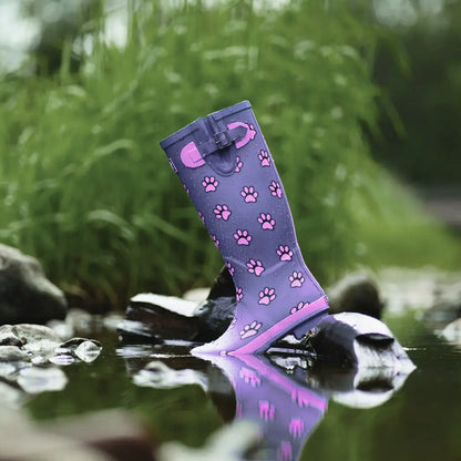 Purple Lazy Dogz Cookie Wellingtons with pink paw prints in shallow water