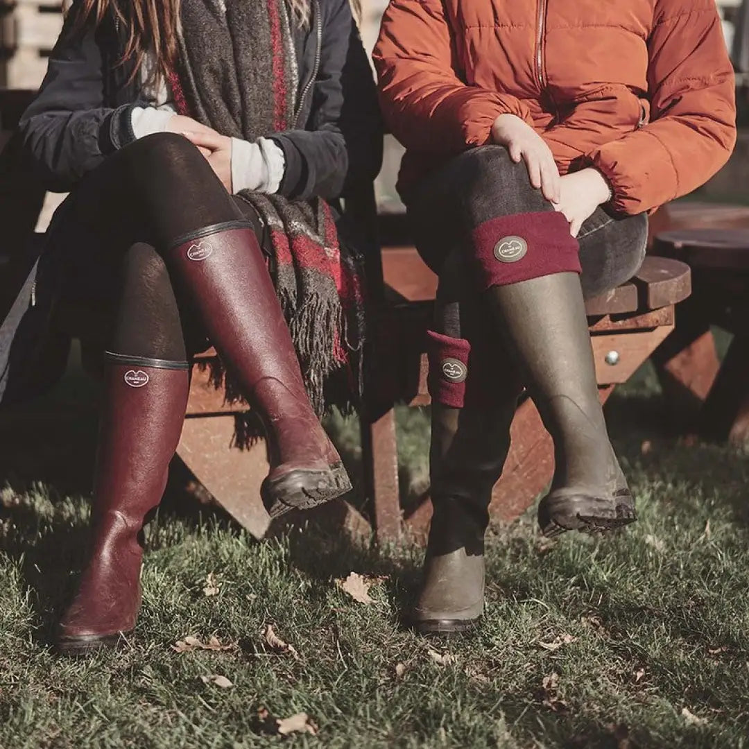 Pair of people in tall boots on grass featuring Chameau Fleece Boot Liners