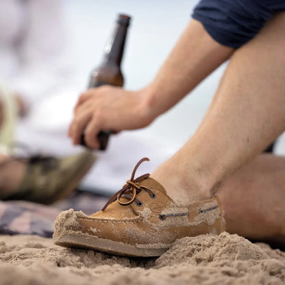 Worn sand-covered Le Chameau Galion Nubuck Mens Deck Shoe on a beach surface