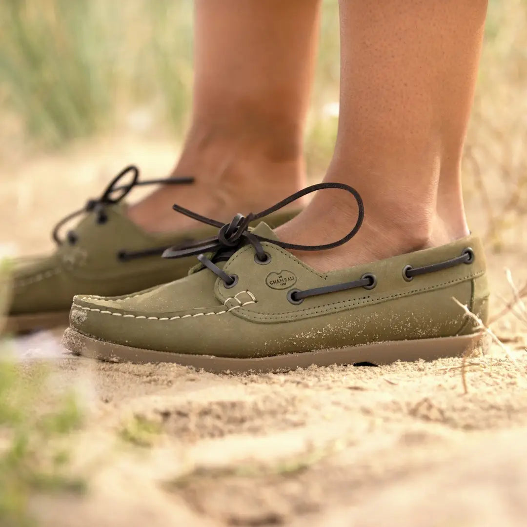 Olive green Galion Nubuck deck shoes with dark laces worn on stylish feet