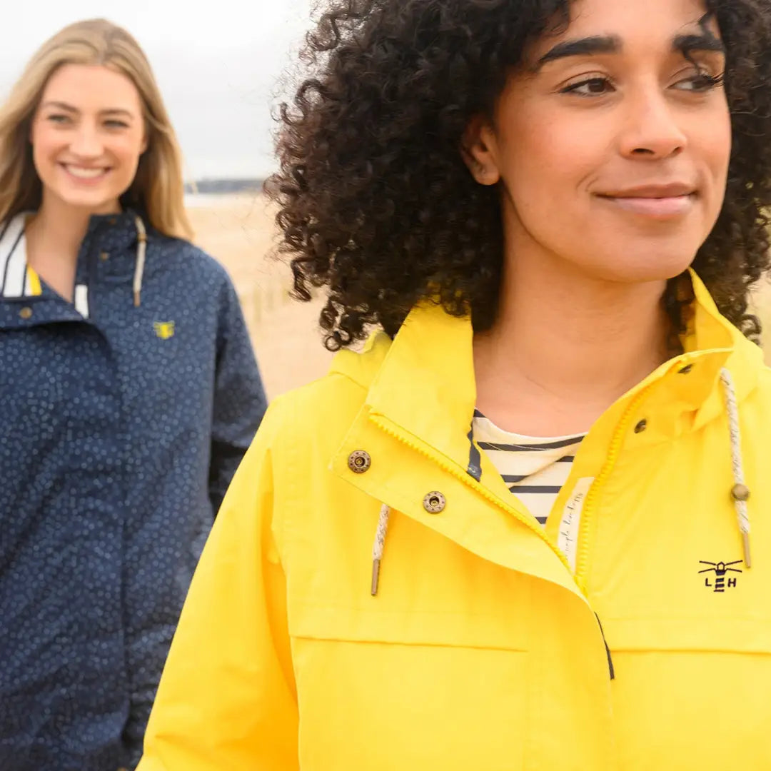 Bright yellow Lighthouse Beachcomber Ladies Waterproof Jacket with high collar and snap buttons