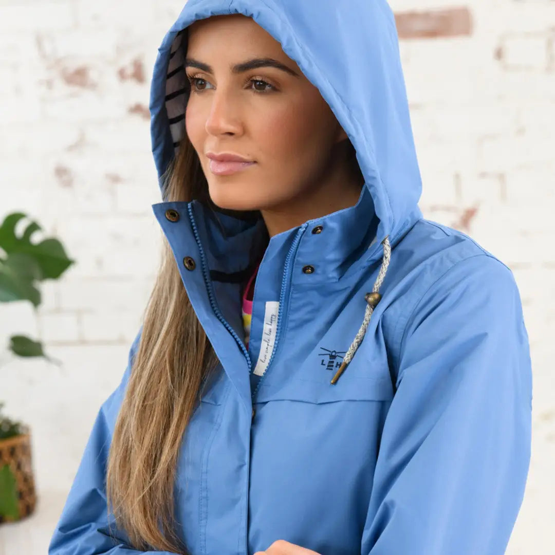 Blue hooded Lighthouse Beachcomber Ladies Waterproof Jacket on a woman with blonde hair