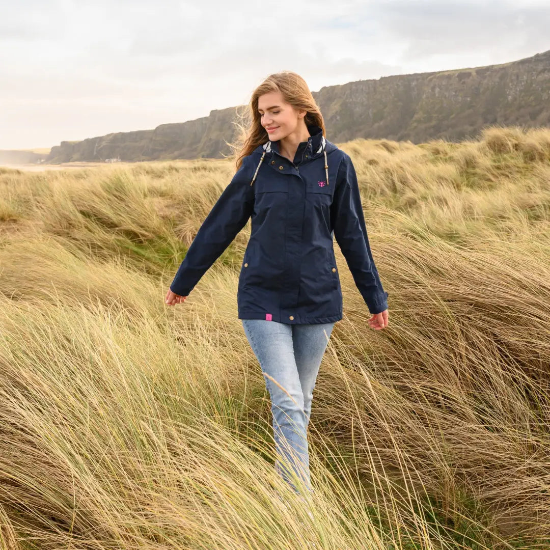 Woman in tall grass wearing a Lighthouse Beachcomber Ladies Waterproof Jacket