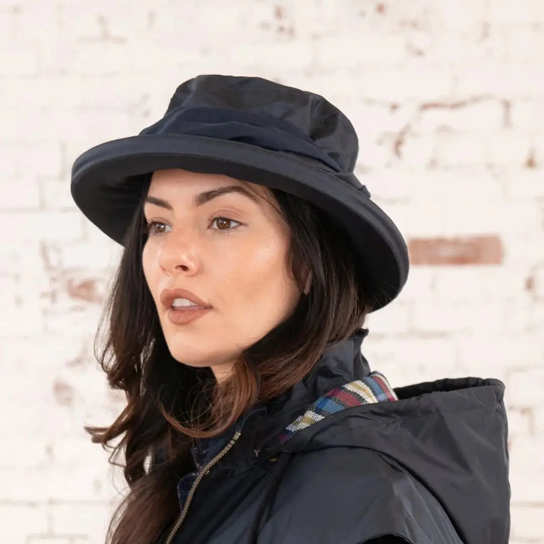 Woman with long dark hair rocking a black Lighthouse Canterbury Waterproof Ladies Hat