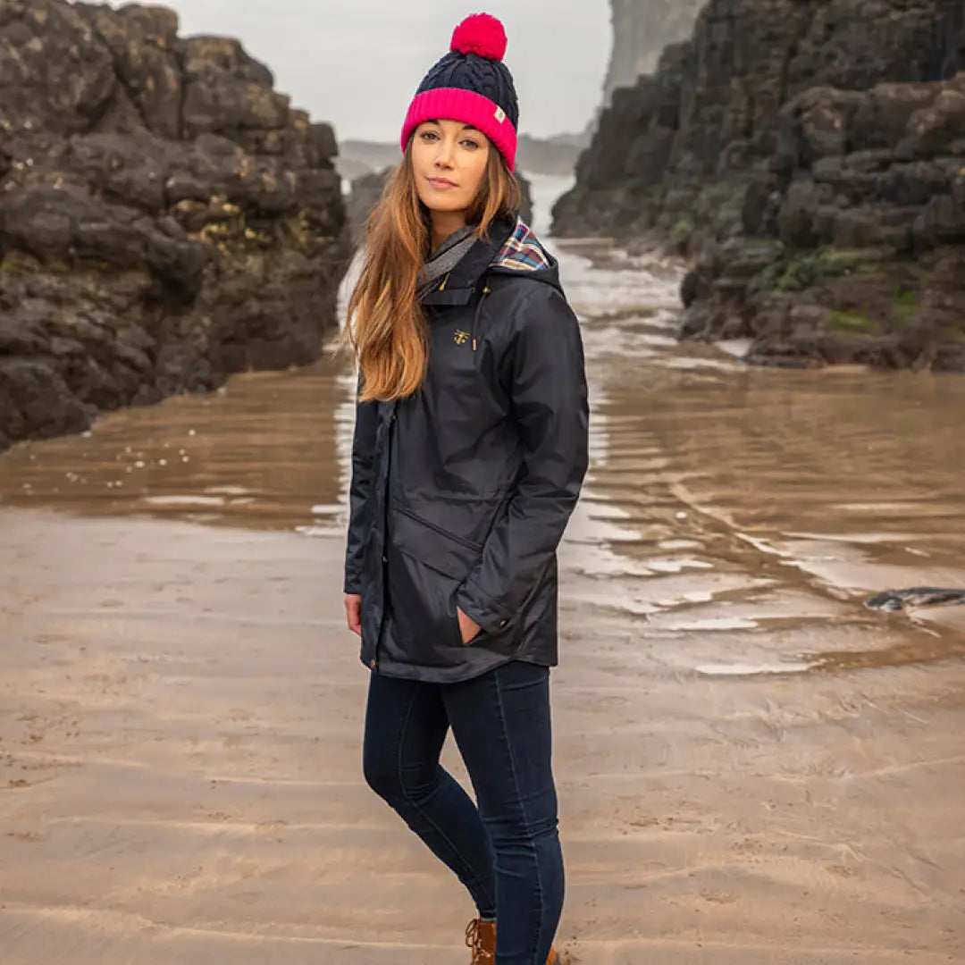 Woman in dark winter coat and pink knit hat from Lighthouse Heritage Collection