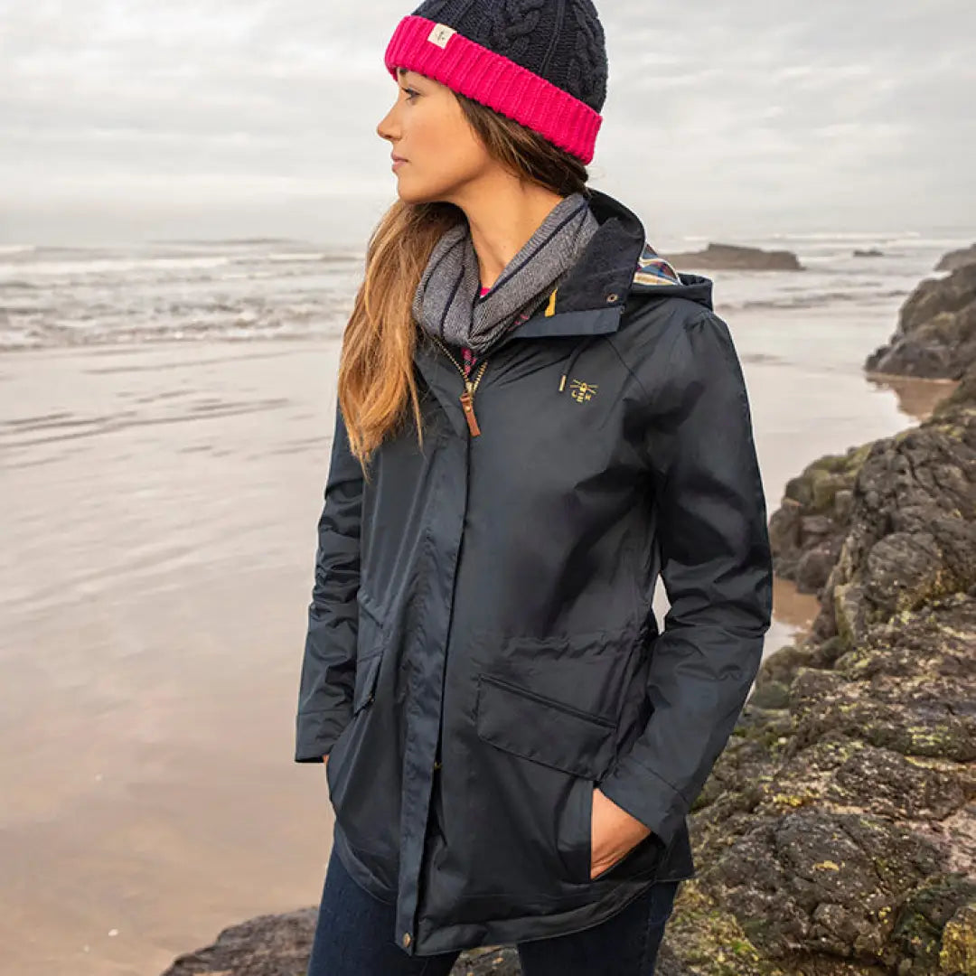 Woman in a dark winter coat and colorful beanie from the Lighthouse Heritage Collection