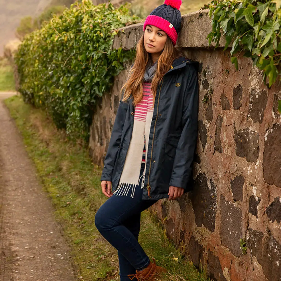 Woman in a black jacket and pink beanie showcasing the Lighthouse Heritage Collection