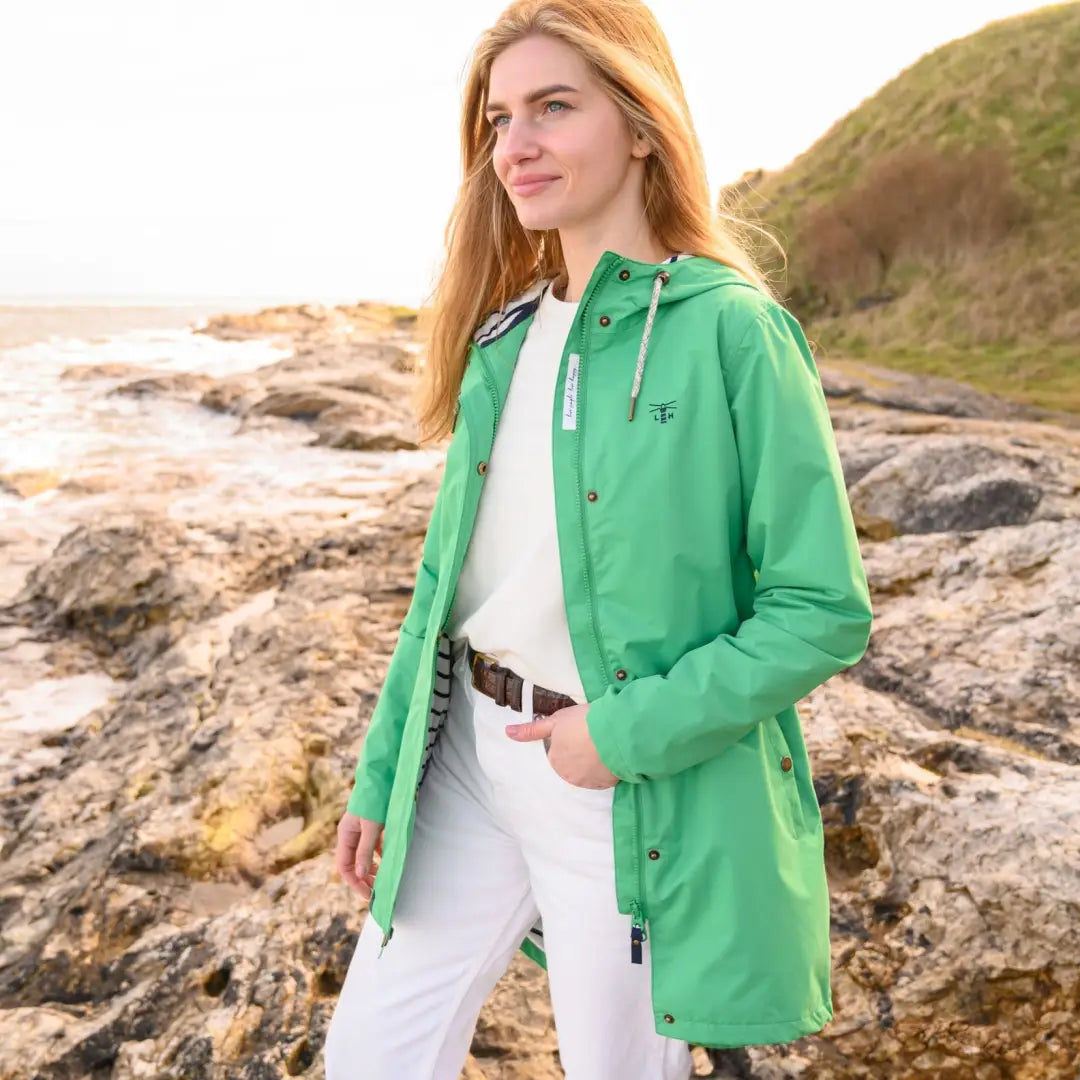 Woman in a green hooded raincoat on rocky coast, Lighthouse Ladies Beachcomber Long Coat