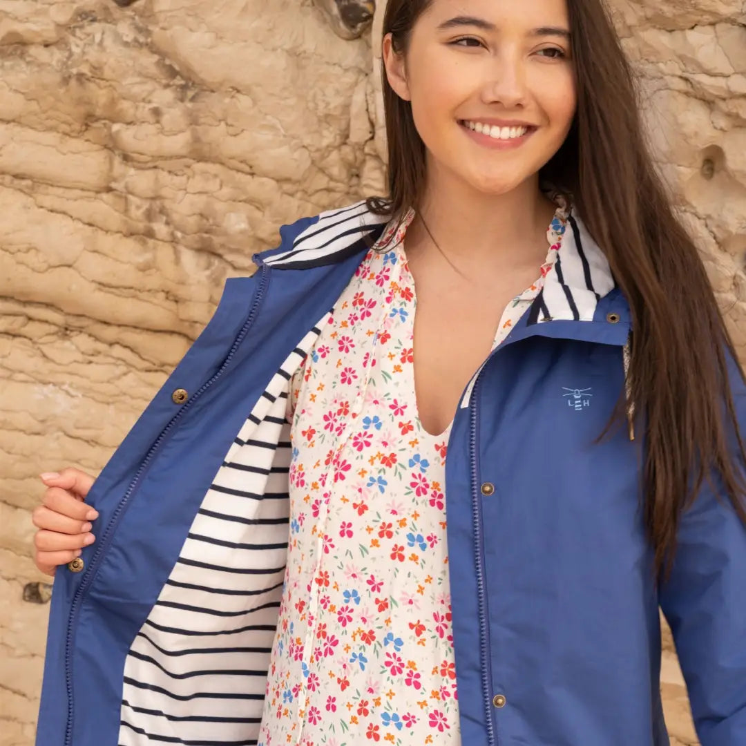 Smiling woman in a blue beachcomber jacket with floral print, perfect for spring summer