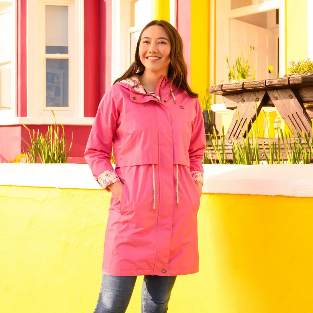 Smiling woman in a bright pink Pippa Coat with soft cotton lining and turnback cuffs