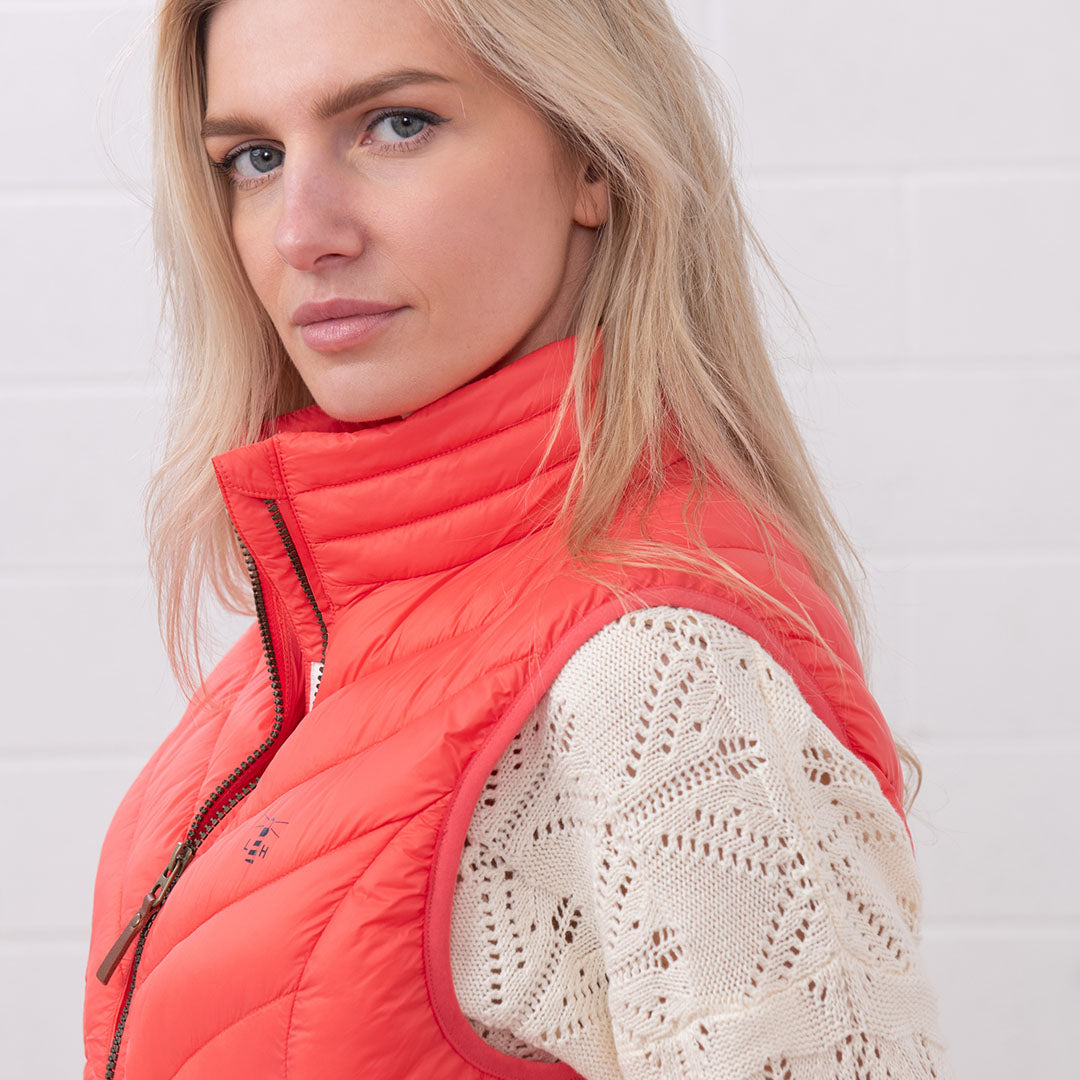 Stylish Woman’s Coral Quilted Vest from Lighthouse Laurel, perfect for country clothing adventures