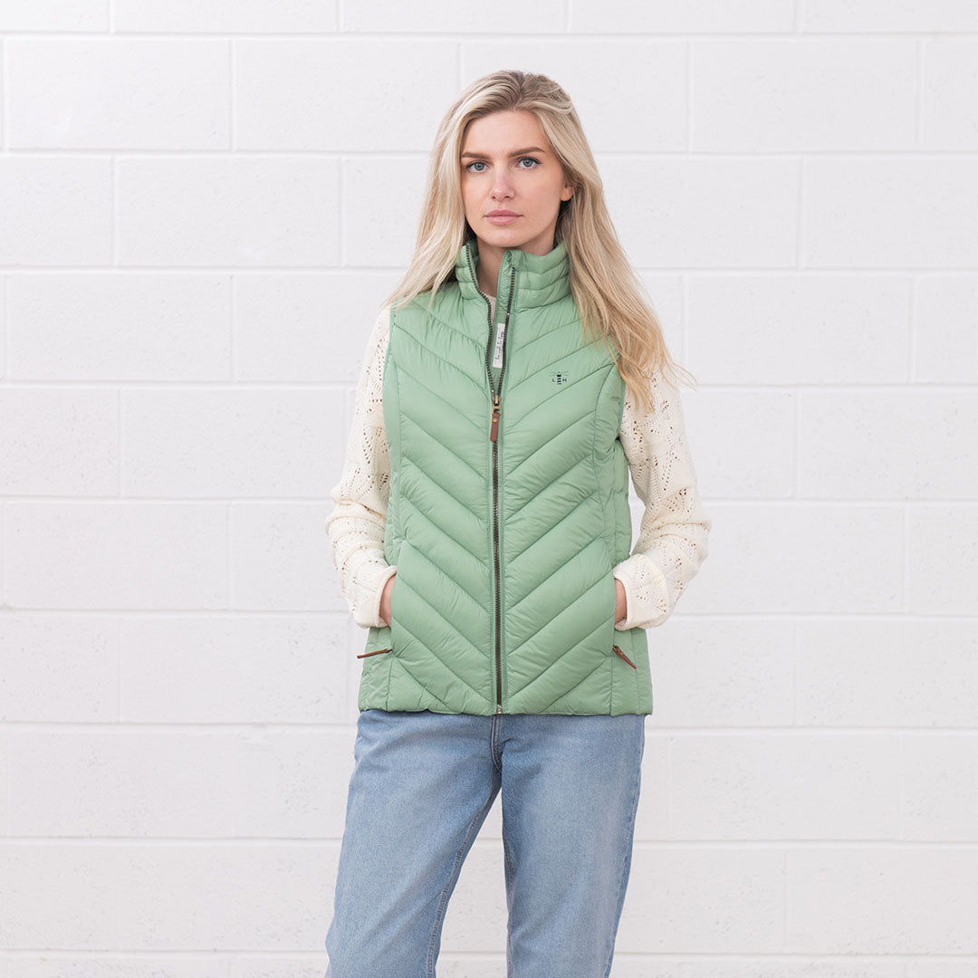 Woman in a light green Lighthouse Laurel Gilet perfect for any casual outing