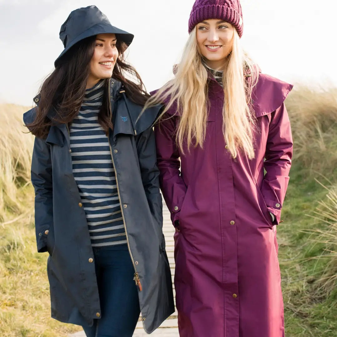 Two women in Lighthouse Outback Full Length Ladies Waterproof Raincoats outdoors