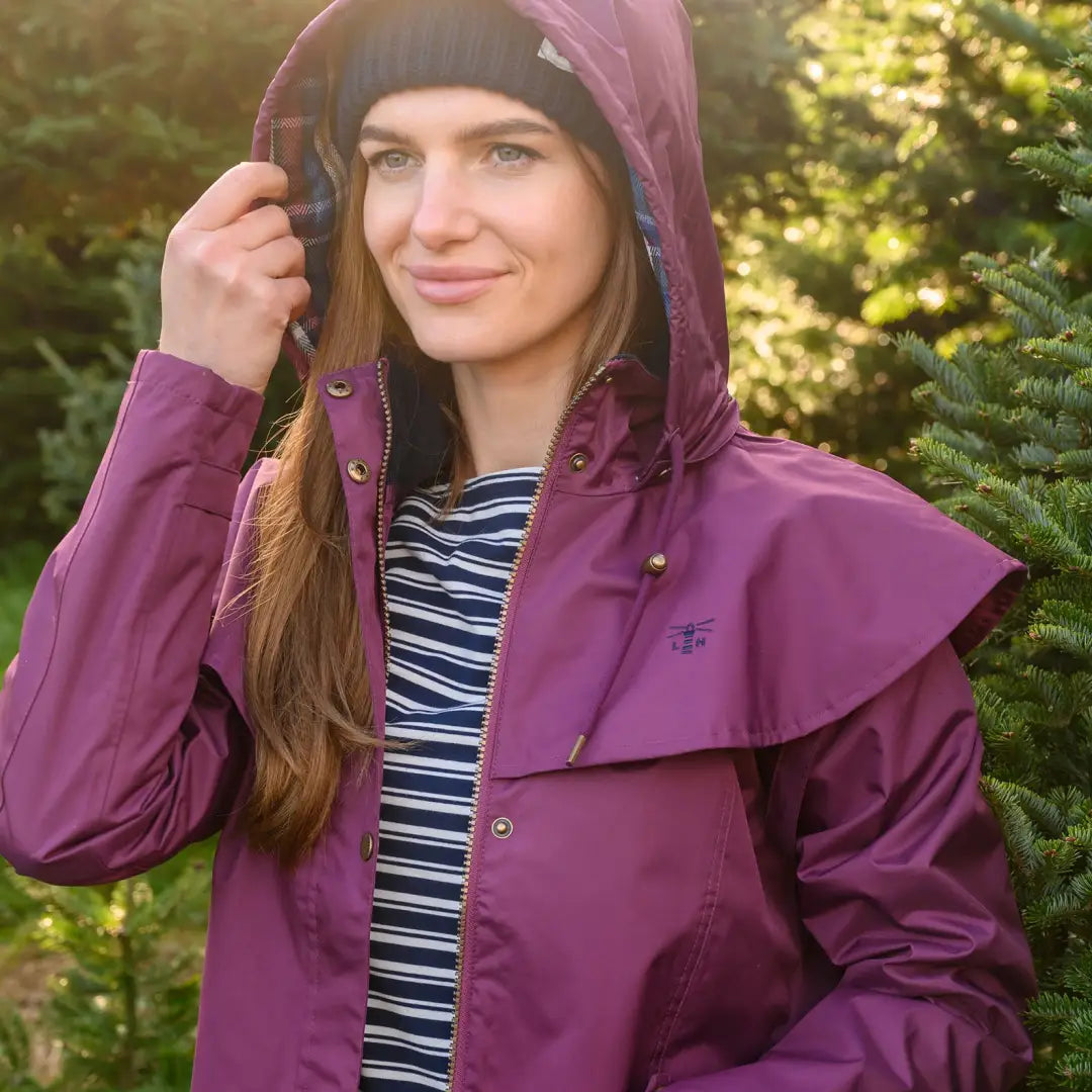 Purple Lighthouse Outrider 3/4 length ladies waterproof raincoat worn outdoors