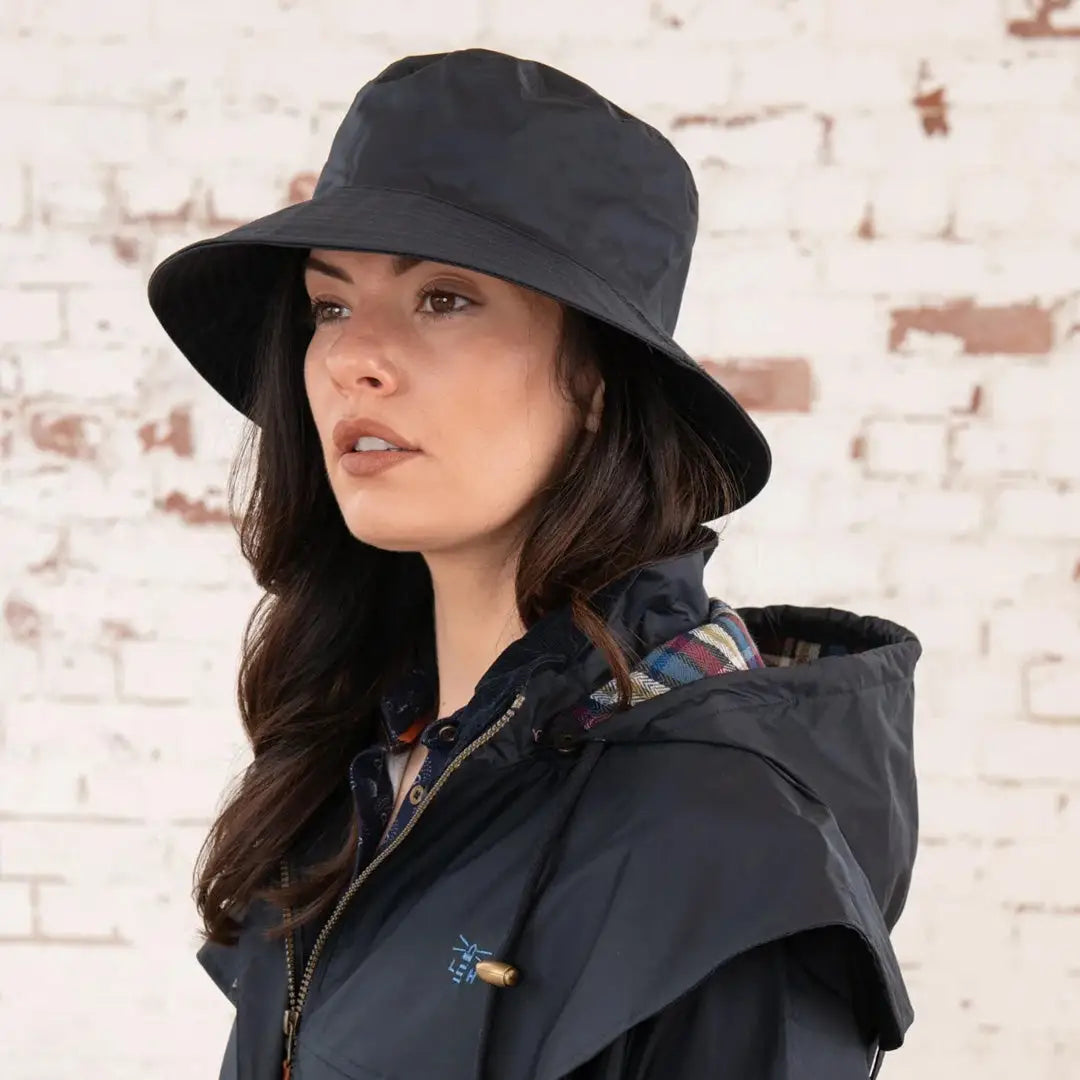 Black wide-brimmed Lighthouse Storm Waterproof Ladies Hat on a woman with long dark hair