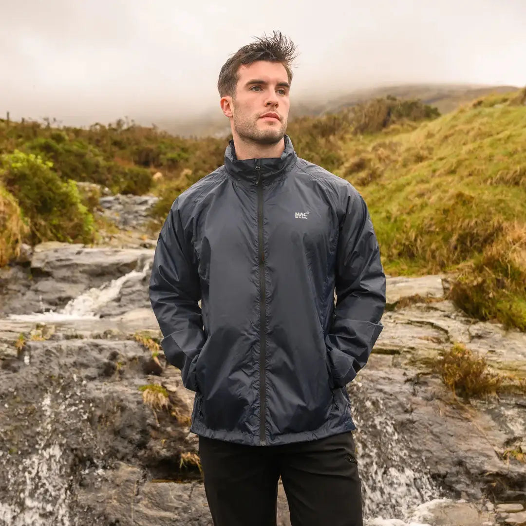 Man in a dark gray Mac in a Sac Origin waterproof jacket with fully taped seams outdoors