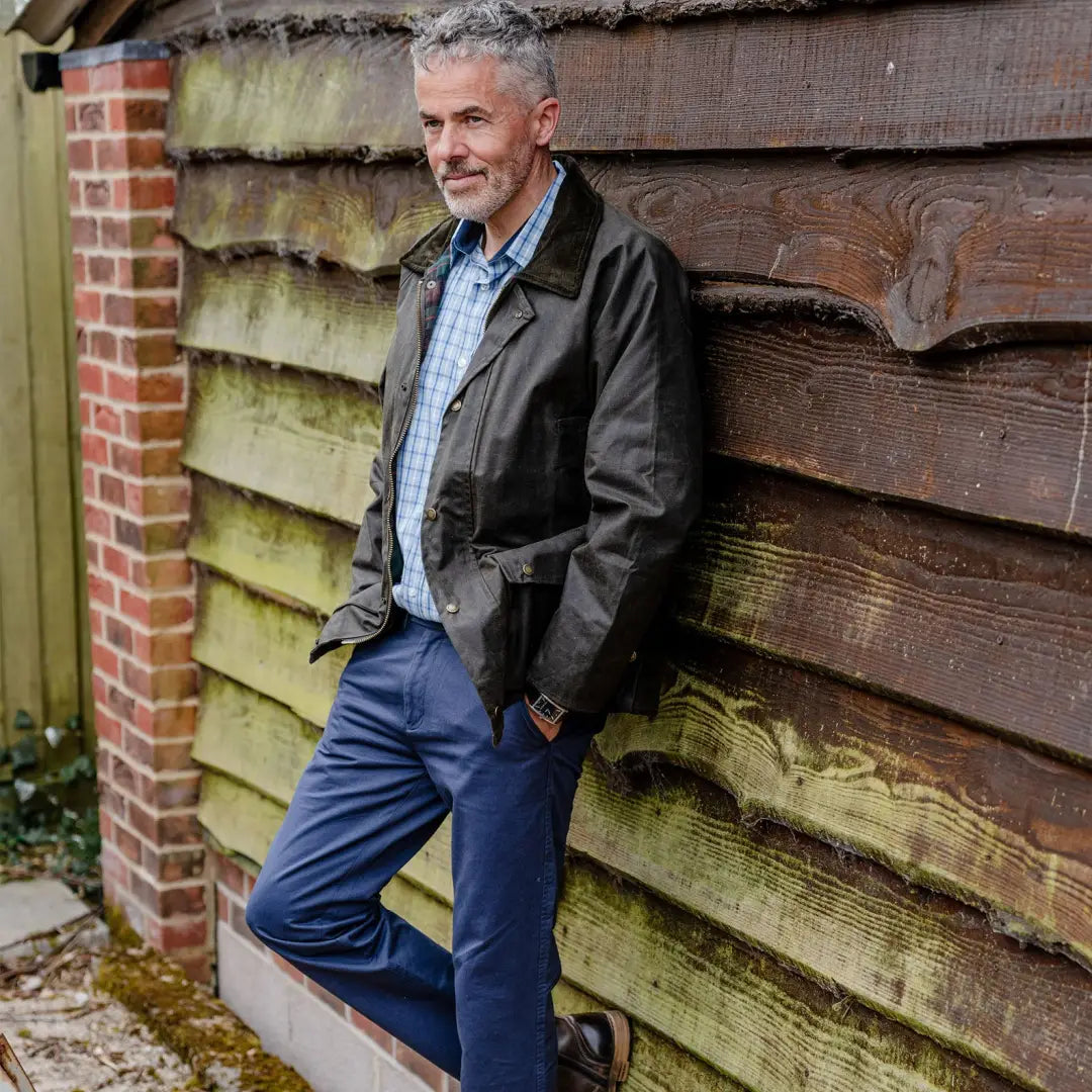 Middle-aged man in dark wax jacket and blue jeans showcasing Mens Classic Antique style