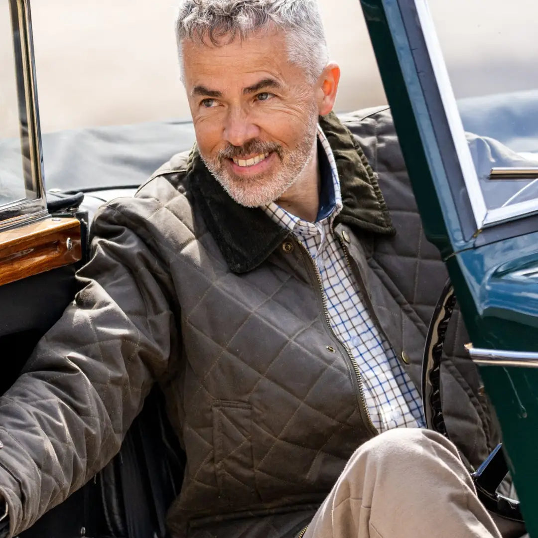 Middle-aged man with gray hair in a stylish quilted wax jacket, perfect for cool weather