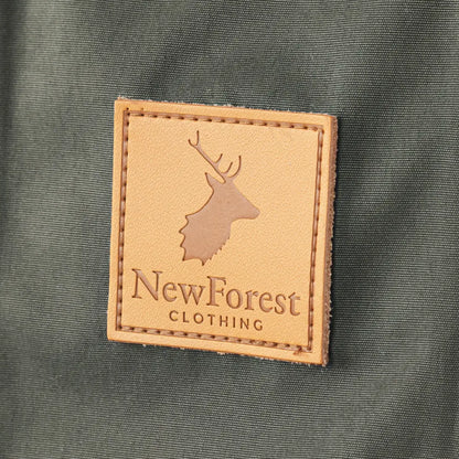 Leather patch with NewForest Clothing logo and deer silhouette on Alice Waterproof Coat