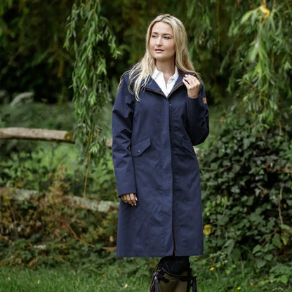 Blonde woman in a Navy Blue trench coat at outdoor setting showing Forest Alice Waterproof coat