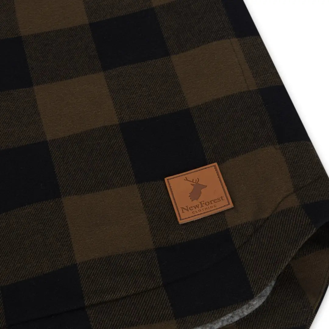 Plaid blanket with deer logo patch perfect for country clothing and hunting vibes