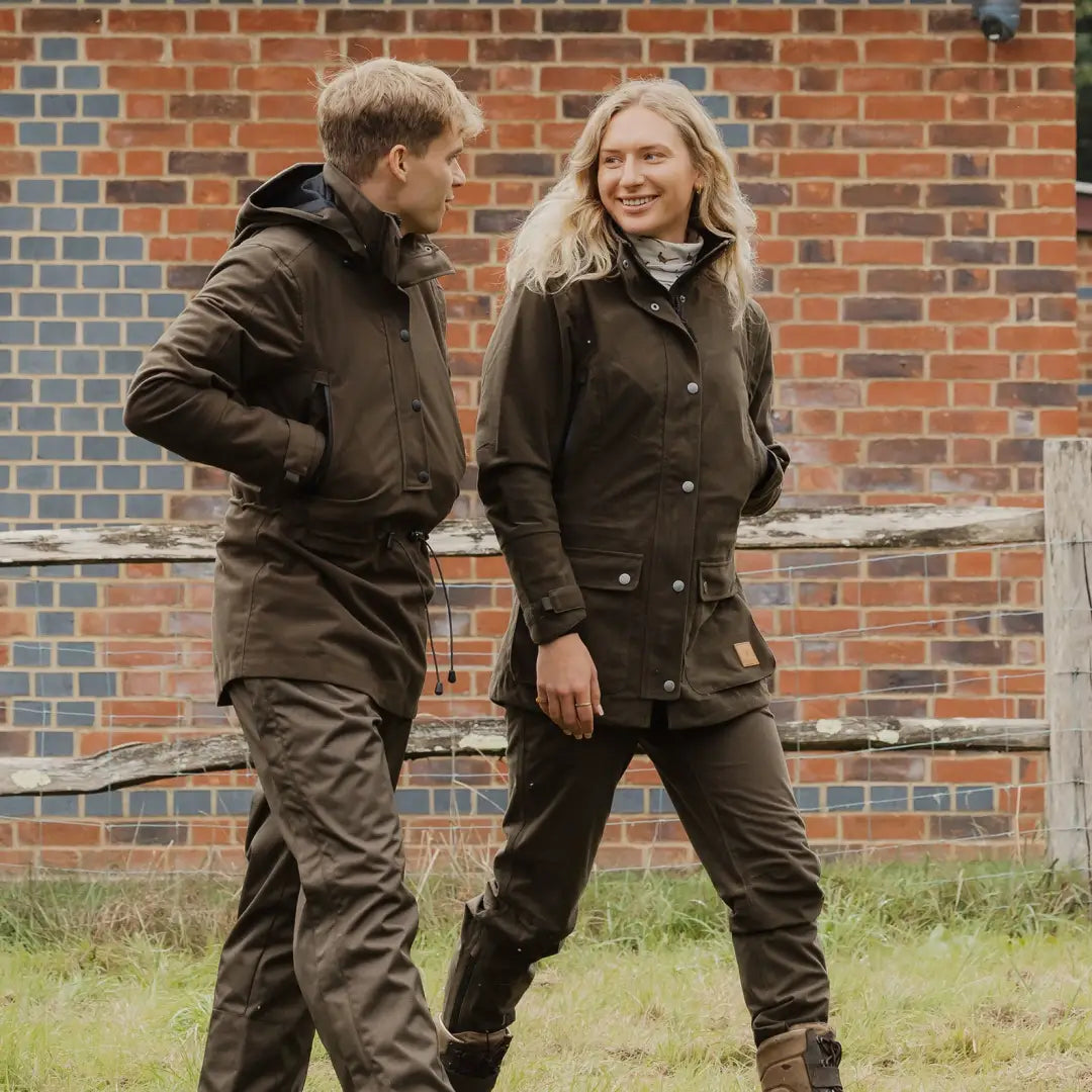 Two people in brown jackets enjoy the outdoors in a Forest Country Sport Smock