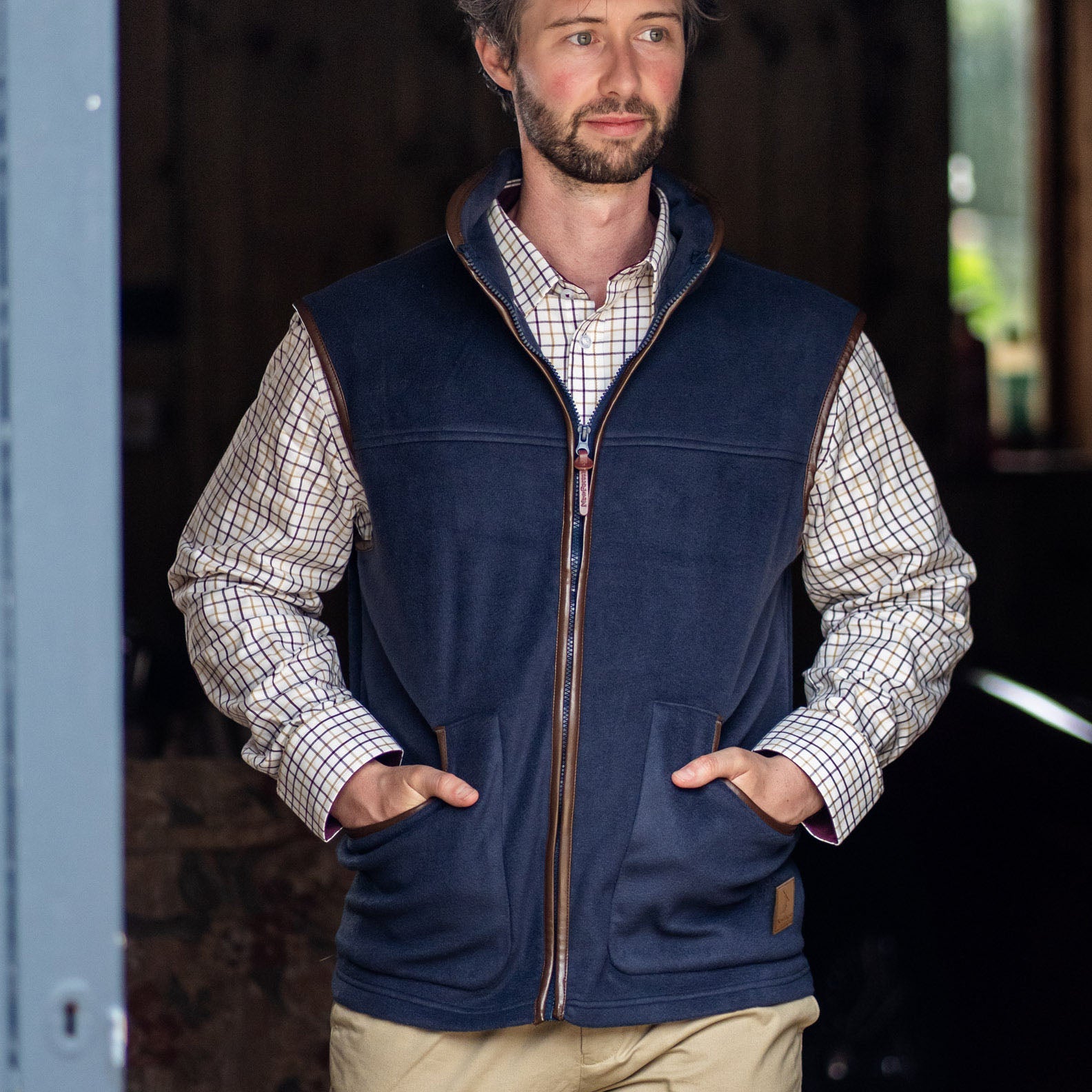 Navy fleece gilet with brown trim perfect for outdoor adventures in the forest