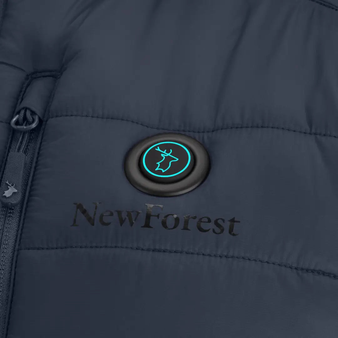 Teal cow icon on NewForest logo button of dark gray New Forest Heated Gilet